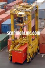 ID 156 PORTS OF AUCKLAND, NZ - Straddle carrier uplifts a 40' container during operations on Ports of Aucklands' Axis Fergusson Container Terminal.